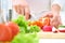 Hands cooking vegetables salad