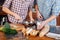 Hands of couple beating eggs and cooking together on kitchen