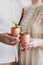 Hands of couple clinking brass goblets with ice citrus cocktail