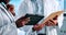 Hands, coworker and tablet for lab results or report with research as healthcare worker. Closeup, doctors and browse