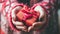 Hands cradling a red heart-shaped gift with ribbon, conveying love and care