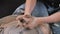 Hands of crafts-artist making craft, pottery, sculptor from fresh wet clay on pottery wheel, Modeling of pottery on the