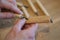 Hands of the craftsman carve with a gouge. Wood carving. Wood carving set on a wooden table.