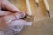 Hands of the craftsman carve with a gouge. Wood carving. Wood carving set on a wooden table.