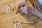 Hands of the craftsman carve with a gouge. Wood carving. Wood carving set on a wooden table.