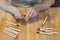 Hands of the craftsman carve with a gouge. Wood carving. Wood carving set on a wooden table.