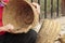 Hands of a craftsman making wicker baskets