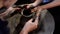 Hands are creating a jar or vase of earthenware on potters wheel