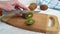 Hands cut kiwi on wooden healthy food
