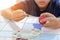 Hands of cute boy painting egg with paintbrush for preparing Easter day. Sunshine effect