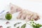 Hands cuting monkfish slices on a white background