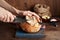 Hands cutting Artisan sourdough toast bread on blue wooden board. Simple breakfast