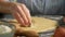Hands cutting dough with star shaped cutter