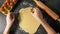 Hands cutting dough with star shaped cutter