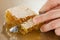 Hands cutting honey honeycombs, closeup