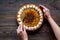 Hands cutting pumpkin pine. Dark wooden background top view copyspace