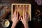 hands delicately arranging ladyfingers in the tiramisu mould