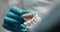 Hands of a dental technician in gloves hold a plaster model of teeth