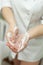 Hands of a dermatologist cosmetologist with a close-up foam. Hygiene and disinfection. Cleansing. Vertical photo