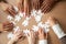 Hands of diverse people assembling jigsaw puzzle together, top v