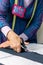 Hands of dressmaker cutting a cloth