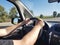 Hands of a driver on car steering wheel