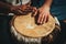 Hands of a drummer playing the ethnic percussion musical instrument djembe