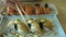 Hands eating aburi engawa nigiri or flounder fin burnt sushi with sauce and mayonnaise Japanese food