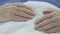 Hands of elderly man lying on stomach, senior male sleeping, having rest in bed