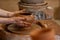 Hands of an elderly potter working with clay on a potter& x27;s wheel