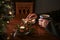 Hands of an elderly single man sitting alone at a table with Christmas cookies, coffee and festive decoration next to an empty