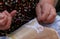 Hands of an elderly woman embroidering a lace with tombolo and c