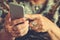 Hands of an elderly woman holding a mobile phone