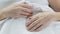 Hands of elderly woman lying in bed, wrinkled skin, aging person, experience