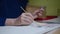 Hands of elderly woman painting with paints and brush on canvas. Senior woman artists hands gracefully drawing on canvas