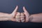 Hands of elderly and young women on black background