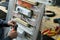 Hands of electrical technician assembling low voltage industrial HVAC control cubicle in workshop. Close-up photo.