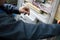 Hands of electrician assembling industrial HVAC control cabinet in workshop. Close-up photo.