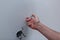 hands of an electrician installing new electrical switches during the house renovation.