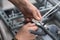 The hands of an electrician strips the ends of the cable to connect to the terminals