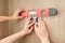 Hands of electrician worker installing electrical outlet in furniture