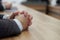 Hands of an elegant man in a business suit on a wooden table. Participant of negotiations or meeting. Anonymous politician,