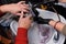 The hands of the employees of the salon and barbershop in the process of washing the client\'s head with water over the sink