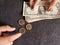 hands exchanging coins of one sterling pound and american dollars bills