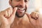 Hands, face and man flossing teeth at home for dental health, plaque and gingivitis on gums. Closeup of guy, oral thread