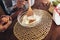 Hands of family, glass container with flour and a broken egg