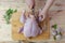 The hands of a female chef carves a whole chicken carcass on a wooden Board, the view from above. Top view