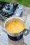 Hands of a female chef prepare citrus syrup. Culinary thermometer