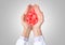 Hands of female doctor with drop of blood on light background