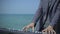 Hands, fingers of musician on digital piano. Young man performs witm synthesizer on azure coast, beach or quay. Male